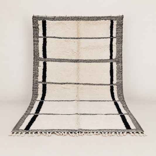 Fascia wool rug with black lines on a square neutral background