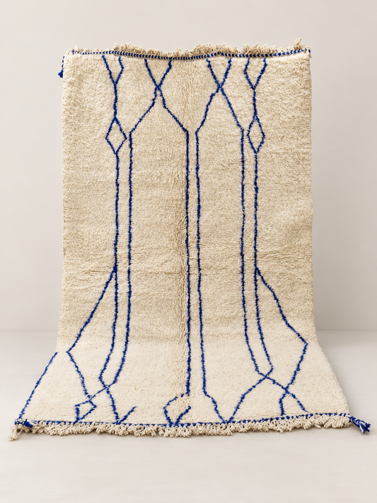 Rivo - hand-knotted wool rug on a light beige background