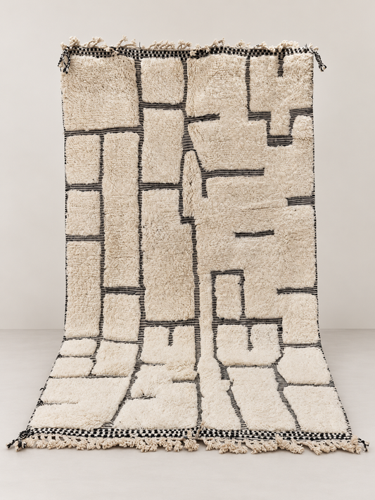 Tessera - hand-knotted wool rug on a light beige background