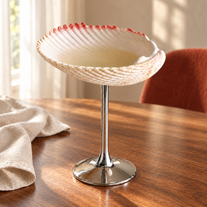 ESTIA shell goblet on a wooden dining table with linen and a rust-coloured chair